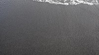 Walau pasir pantainya berwarna hitam, pemandagnan di sana tidak kalah menarik. Raam aktivitas bisa dilakukan pengunjung di sini. (iStock)