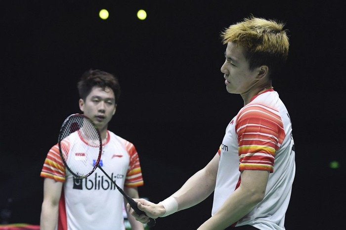 Indonesias Marcus Fernaldi Gideon and Kevin Sanjaya Sukamuljo (R) react after losing a point against Japans Takeshi Kamura and Keigo Sonoda during their mens doubles semi-final match at the 2019 Sudirman Cup world badminton championships in Nanning in Chinas southern Guangxi region on May 25, 2019. (Photo by WANG ZHAO / AFP)
