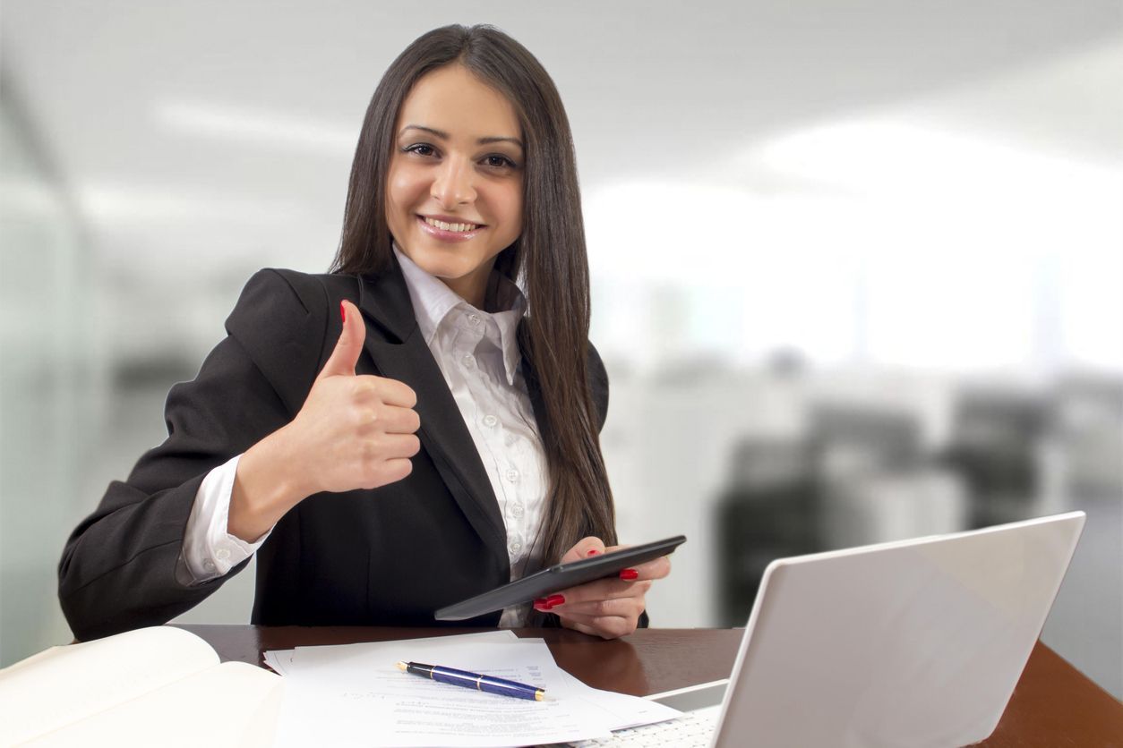 Multi-tasking succesfull businesswoman in office interior