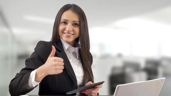 Multi-tasking succesfull businesswoman in office interior