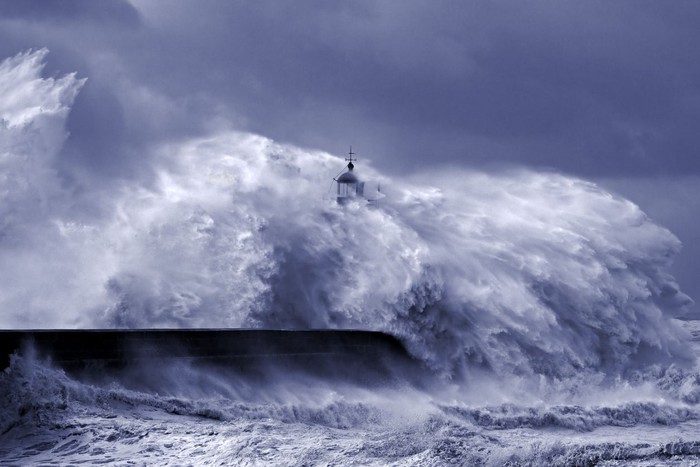 Heavy storm at the mouth of Douro river, Porto, Portugal. Black and white toned blue.