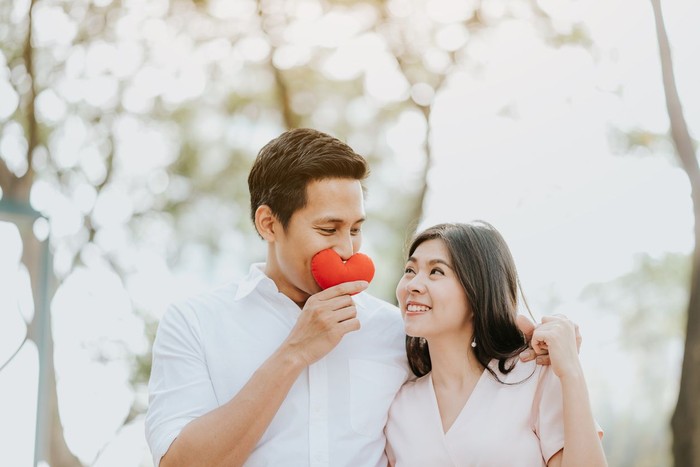 Tanda Siap Jatuh Cinta Lagi Precious moments of love. Close up portrait of handsome bearded guy kissing his girlfriend in cheek while she hugging him. Lady closing eyes with pleasure and smiling