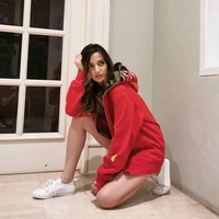 Nia Ramadhani berpose jongkok cantik dengan busana sporty berupa hoodie oversized dan sneakers Givenchy. Di Amerika Serikat, gaya jongkok ini dikenal dengan sebutan hot squat. Foto: Instagram