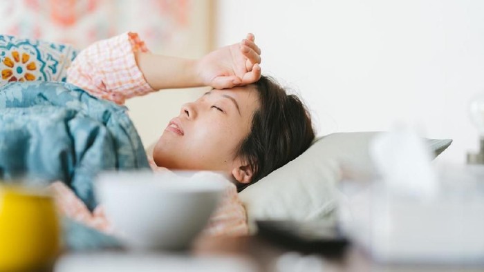 anemia A women is feeling sick and sleeping on a sofa at home.