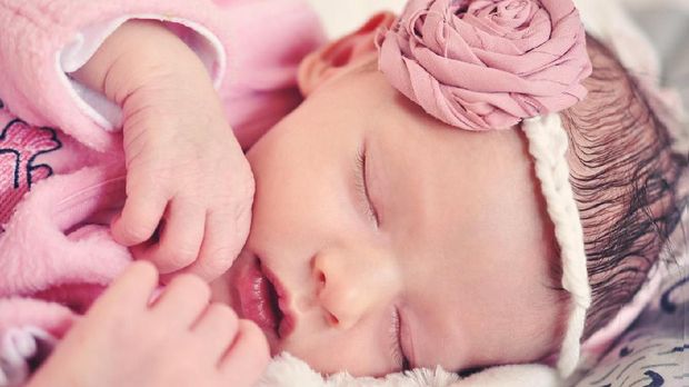 Newborn Beautiful Little Girl Sleeping On a Bed