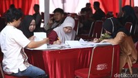 Warga mengisi berkas pendaftaran.