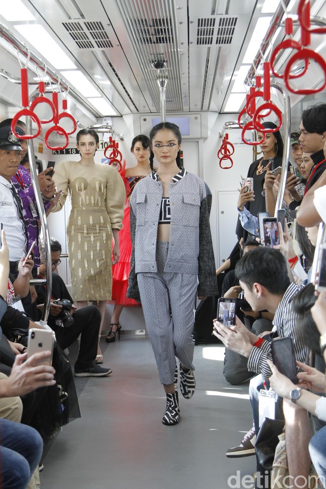 Seperti inilah momen para model mencetak sejarah melakukan fashion show pertamakalinya di gerbong LRT (Lintas Rel Terpadu) Jakarta. Para model berlenggak-lenggok di gerbong kereta yang menjadi catwalk mereka. Foto: Muhammad Abduh/Detikcom