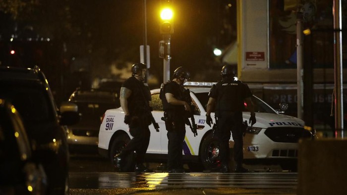 Authorities continue their investigation of a shooting where multiple police officers were shot, Wednesday, Aug. 14, 2019, in Philadelphia. (AP Photo/Matt Rourke)