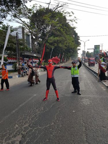 Sosok Spiderman yang menyeberangkan pelajar di Malang/