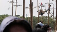 Satu per satu peserta berupaya untuk dapat mencapai puncak pohon pinang dan membawa pulang beragam hadiah yang menggantung di sana.