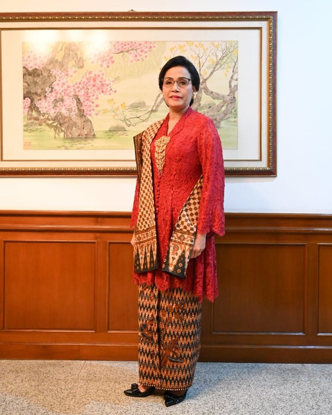 Menteri Keuangan Sri Mulyani tampil anggun dalam kebayaya brokat merah rancangan Didiet Maulana. Busana yang disebut Kebaya Kartini Nusa itu dibuat dari brokat merah yang dipadukan dengan kain kuno bermotif Tirto Tejo Buketan dan dipasangkan dengan selendang batik antik. Usia kedua kain tersebut diperkirakan hampir mencapai 50 tahun. Itu koleksi pribadi Ibu, ucap sang desainer Didiet Maulana. Foto: Istimewa/Dok. Didiet Maulana