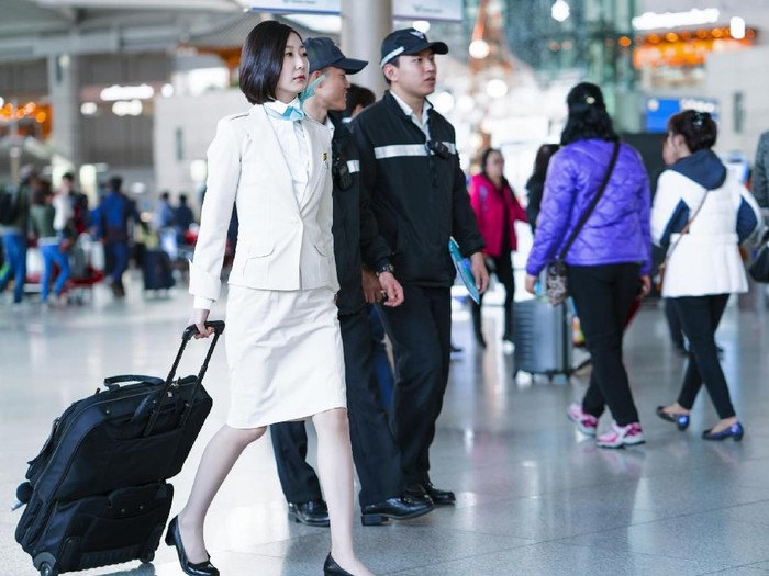 621243938 Incheon, South Korea - February 15, 2016: Asian Korean female air flight attendant in International airport of Incheon. It is one of the largest and busiest world airports.