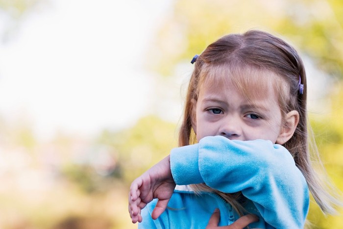 This sweet little girl shows the viewer the correct way to sneeze or cough by using the inside of her elbow and not her hands.