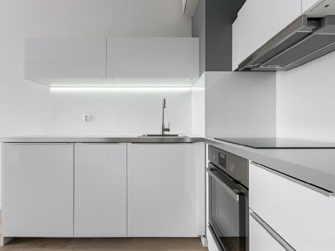 Young boy, home alone, trying to reach for something from a kitchen cabinet