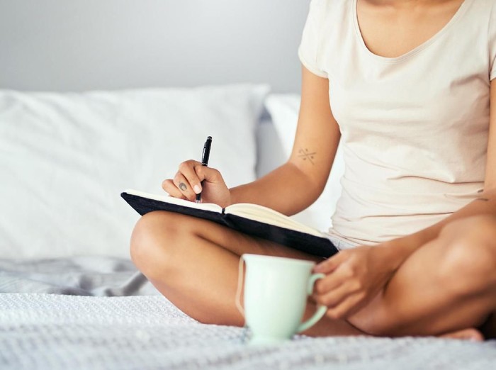 Asian women drinking coffee and wake up in her bed fully rested and open the curtains in the morning to get fresh air on sunshine