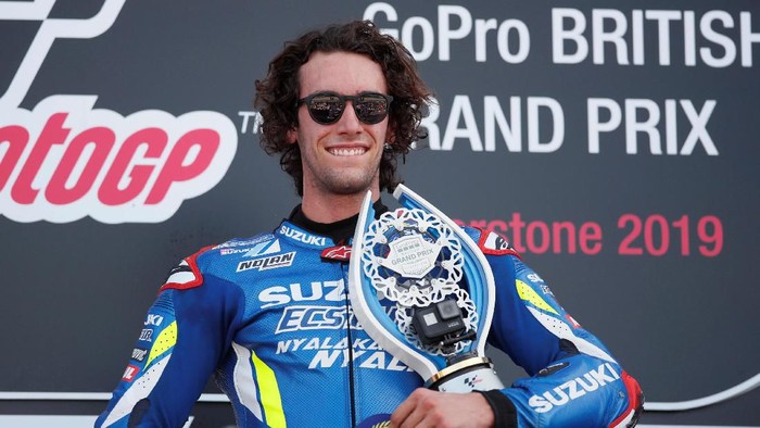 MotoGP - British Grand Prix - Silverstone Circuit, Silverstone, Britain - August 25, 2019  Team Suzuki Ecstars Alex Rins celebrates on the podium with award after winning the race   REUTERS/David Klein