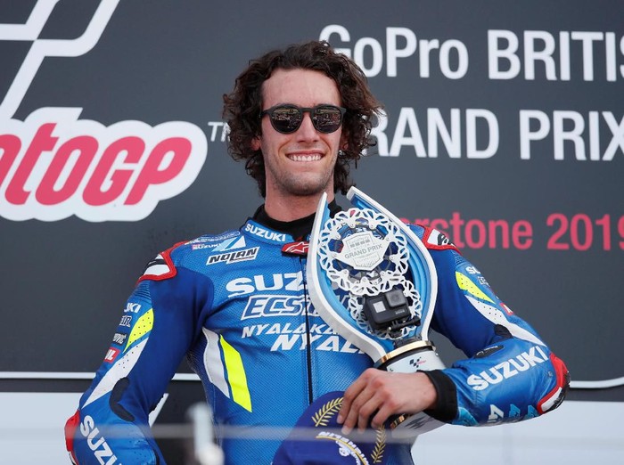 MotoGP - British Grand Prix - Silverstone Circuit, Silverstone, Britain - August 25, 2019  Team Suzuki Ecstars Alex Rins celebrates on the podium with award after winning the race   REUTERS/David Klein
