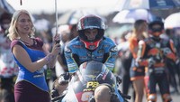 Didampingi seorang umbrella girl, Xavi Vierge mencoba berkonsentrasi jelang start MotoGP Inggris (Mirco Lazzari gp/Getty Images)