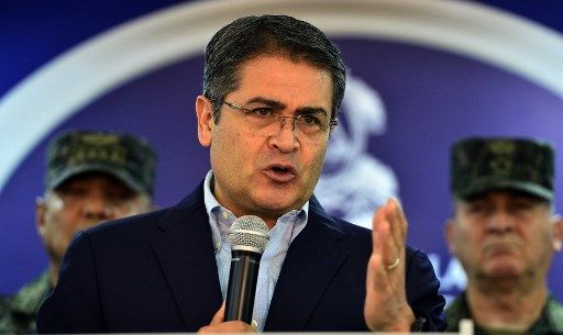 Honduran President Juan Orlando Hernandez Honduran President Juan Orlando Hernandez speaks at the presidential house in Tegucigalpa, on June 20, 2019. - Thousands of Hondurans blocked streets across the country while looters raided and torched businesses in the capital Wednesday night demanding the resignation of Hernandez as tensions mount over strikes by police and truckers. (Photo by ORLANDO SIERRA / AFP)