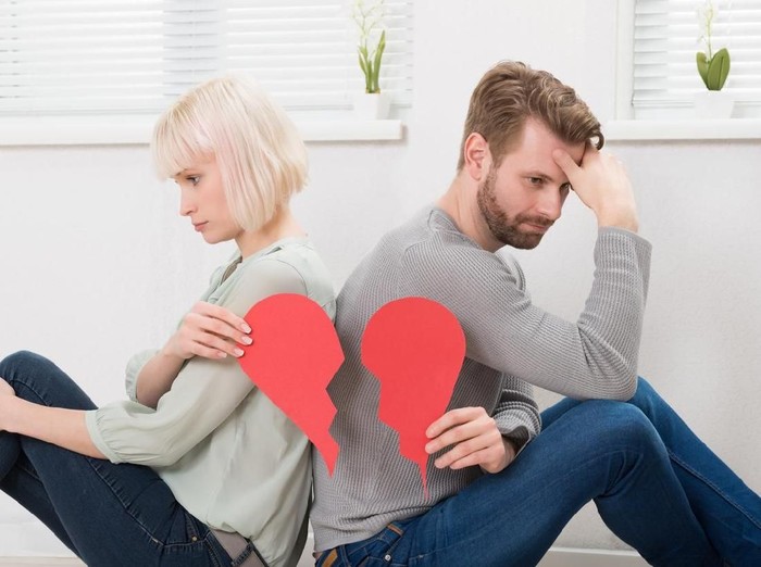 pasangan putus cinta Sad Couple Sitting Back To Back Holding Red Broken Heart