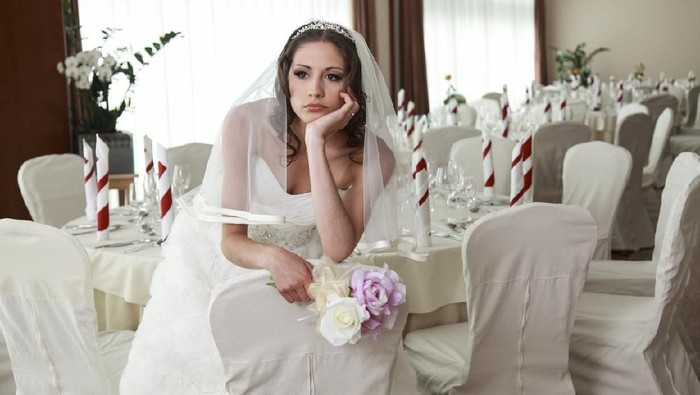 ilustrasi pengantin sedih Bride sitting in a ceremony waiting restaurant. Sitting sad with head and flowers in her hands.