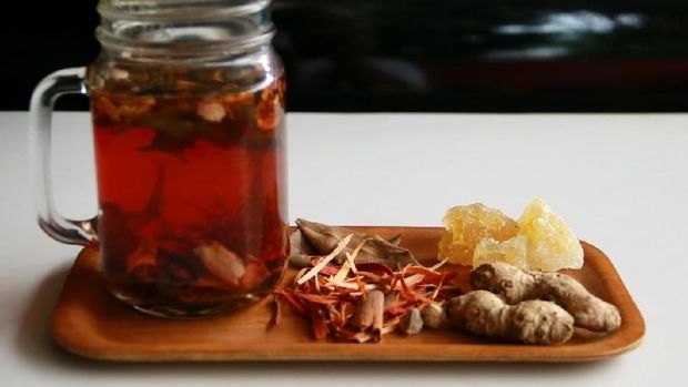 Wedang Uwuh, traditional herb drink from Jogjakarta, Indonesia. Contains a variety of leaves: cinnamon, nutmeg and cloves leaves. Another ingredient is wood from the secang tree, ginger and lump sugar