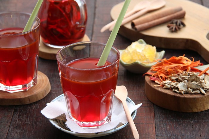 694655252 Wedang Uwuh, traditional herb drink from Jogjakarta, Indonesia. Contains a variety of leaves: cinnamon, nutmeg and cloves leaves. Another ingredient is wood from the secang tree, ginger and lump sugar