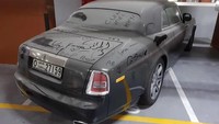 Pertama ada Rolls-Royce Phantom Coupe. Mobil sedan termahal dan termewah Rolls-Royce itu tak terhindarkan dari nasib terlantar di Dubai. Phantom ditinggalkan untuk waktu yang lama di lantai dasar apartemen di Dubai. Mobil ditutupi debu tebal. Saking tebalnya debu yang menutupi sampai bisa dicoret-coret orang. Foto: Zing