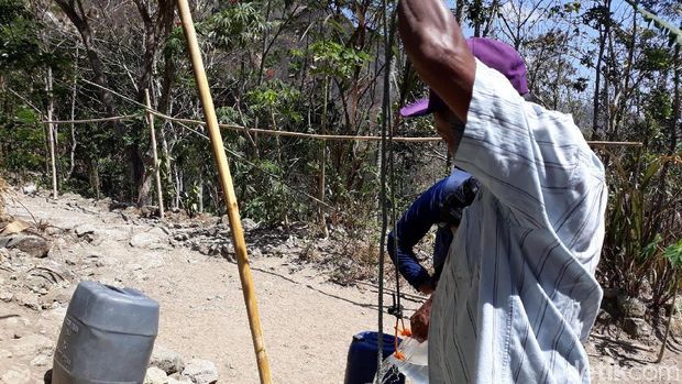 Warga Gunungkidul mengambil air dari sumur bor pakai toples plastik. 