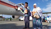 Dua jemaah haji langsung berdoa setelah mendarat di Bandar Sultan Iskandar Muda, Blang Bintang, Aceh Besar, Aceh, Selasa (3/9/2019). Jemaah yang diberangkatkan dari kloter pertama ini berjumlah 393 jemaah. Namun satu orang wafat di Mekah, Arab Saudi.