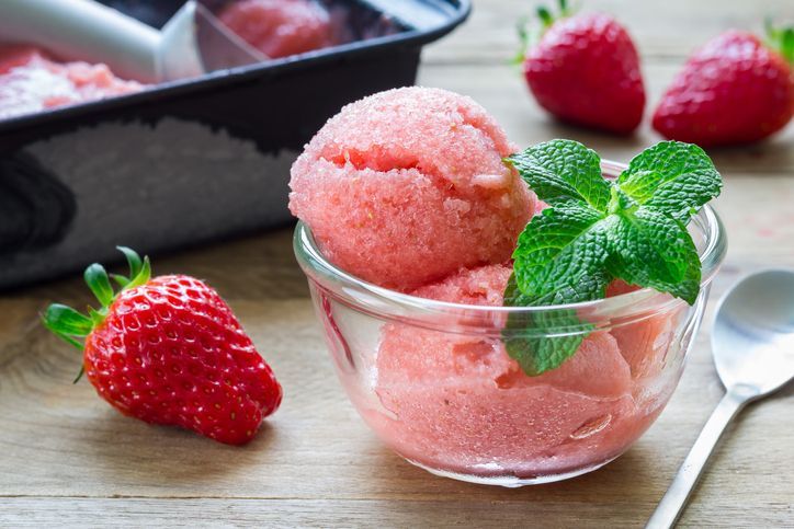 Fruit strawberry sorbet with fresh berries on rustic background