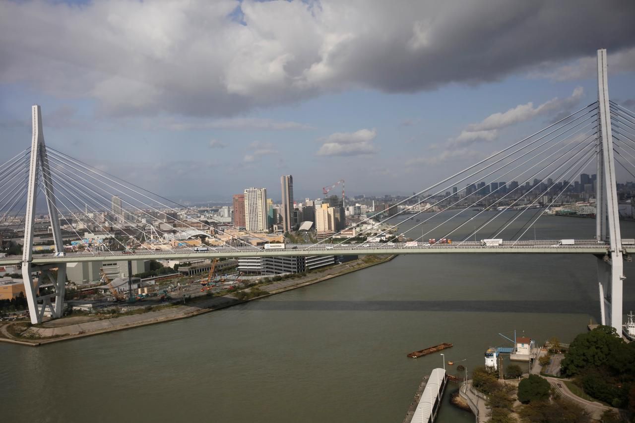 Cars cross the Tempozan bridge in front of the skyline of Osaka, Japan October 23, 2017. REUTERS/Thomas White