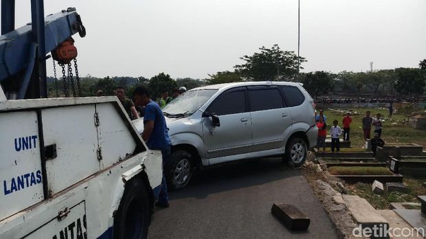Mobil terguling dan menimpa makam di TPU Tanah Kusir, dievakuasi, Jumat (6/9/2019)