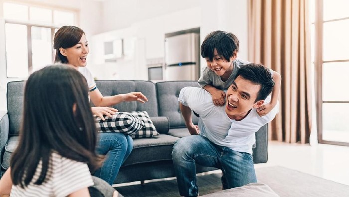 Asian ethnicity family with two children having fun at home