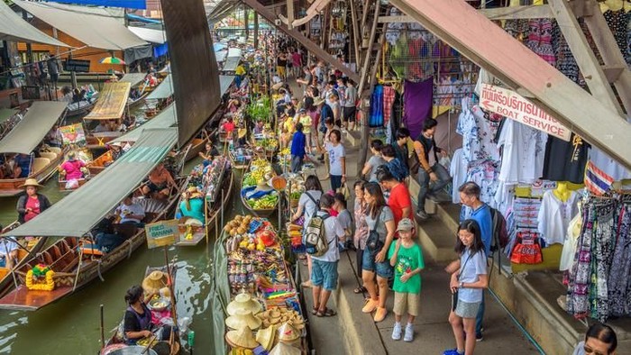 Local farmers and traders selling food and produce at a colourful floating market in Bangkok, Thailandâ€™s vibrant capital city.