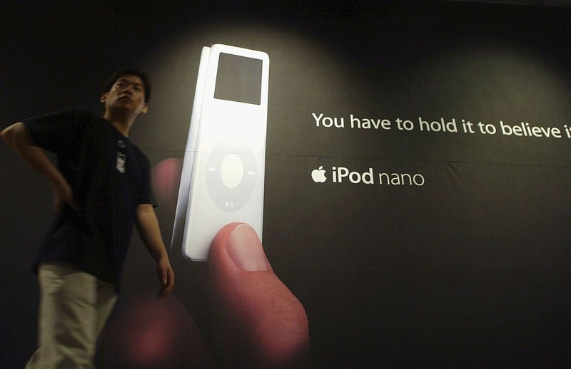 SEOUL, SOUTH KOREA - SEPTEMBER 22: A man walks past an advert displaying the latest iPod nano at a press launch on September 22, 2005 in Seoul, South Korea. The latest release from Apple features a 4 GB model with the capacity to store up to 1,000 songs or 25,000 photographs. The iPod nano weighs 1.5 ounces and, measures only 3.5 x 1.6 x 0.27 inches. The 4 GB model will be available on the Korean market at $290 USD and the 2 GB version available for $230 USD. (Photo by Chung Sung-Jun/Getty Images)