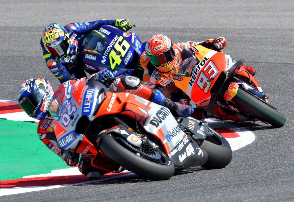 Ducati Team's Italian rider Andrea Dovizioso (front), Repsol Honda Team's Spanish rider Marc Marquez (R) and Movistar Yamaha MotoGP's Italian rider Valentino Rossi take a bend during the last free practice session of the San Marino Moto GP Grand Prix race at the Marco Simoncelli Circuit in Misano on September 8, 2018. (Photo by Tiziana FABI / AFP)