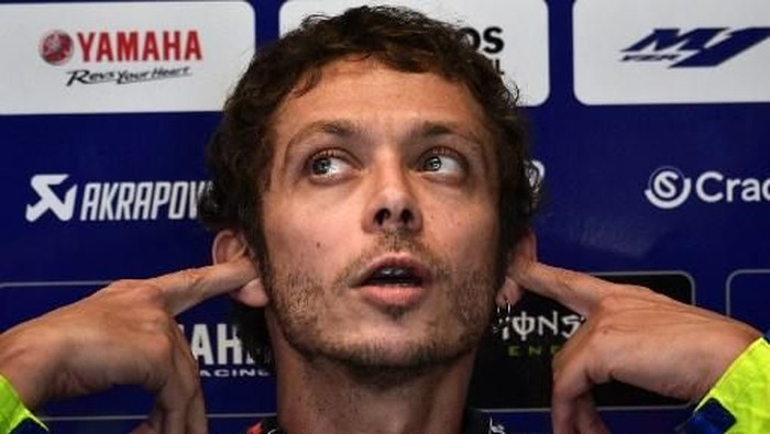Monster Energy Yamaha Italian rider, Valentino Rossi covers his ears as he sits in the stands during a free practice session ahead of the San Marino MotoGP Grand Prix race at the Misano World Circuit Marco Simoncelli on September 13, 2019. (Photo by Marco BERTORELLO / AFP)
