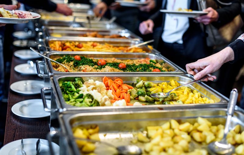 Closeup Of Business People's Hands Having Lunch Together