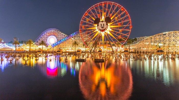 Anaheim, CA USA - August 22, 2015: Disneyland 60th aniversary at Cars Land. This year Disneyland celebrates its 60th aniversary of been open. On this day the park celebrated with fireworks and over 150 thousand people. People walk around rides and games at the downtown Cars Land during the night time..