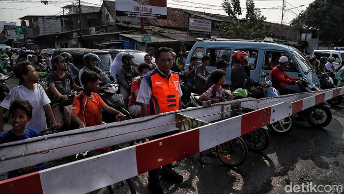 Petugas KAI Daop 1 Jakarta melakukan sosialisasi keselamatan berlalu lintas di perlintasan sebidang Bukit Duri Manggarai, Jakarta, Selasa (17/9). Dengan sosialisasi tersebut, diharapkan kesadaran masyarakat untuk menaati aturan lalu lintas di perlintasan sebidang semakin meningkat.
