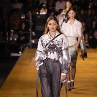 Fashion show Burberry turut diramaikan dengan penampilan Gigi Hadid. Ia menebar pesonanya dengan kemeja longgar dan celana panjang high-waist. (Foto: Vianney Le Caer/Invision/AP)
