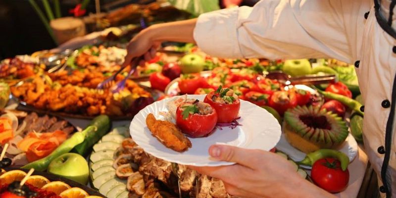 Closeup Of Business People's Hands Having Lunch Together