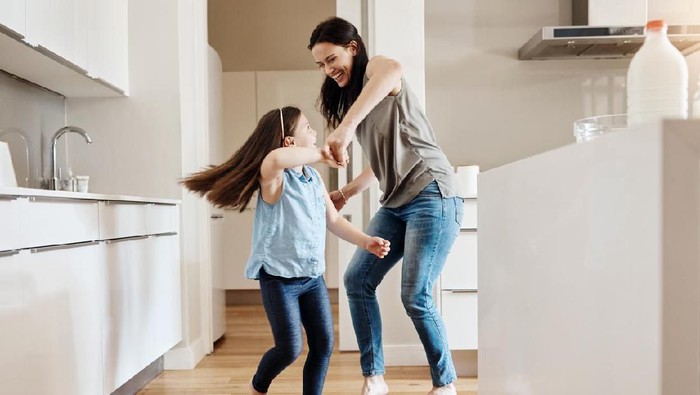 Shot of an adorable little girl dancing with her mother at home
