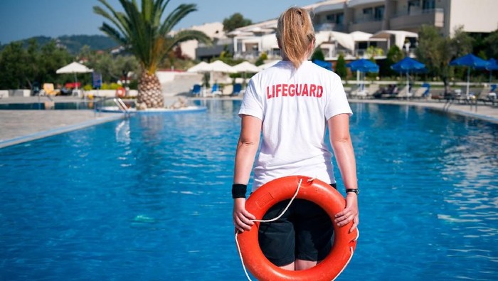 female lifeguard on duty at a swimming pool