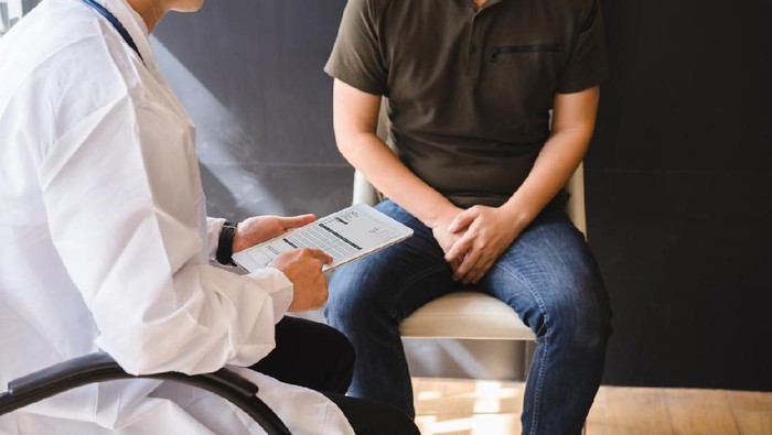 Male doctor and testicular cancer patient are discussing about testicular cancer test report. Testicular cancer and prostate cancer concept.