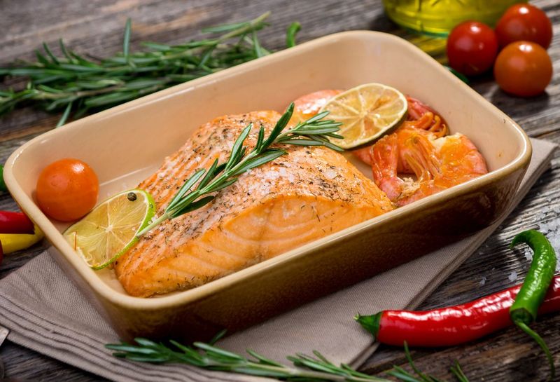 portions of fresh salmon fillet with aromatic herbs, spices and vegetables