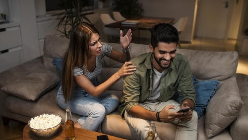 Jealous suspicious mad wife arguing with obsessed husband holding phone texting cheating on cellphone, distrustful girlfriend annoyed with boyfriend mobile addiction, distrust social media dependence