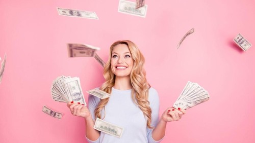 Young brunette curly female reading her bill papers, looking stressed
