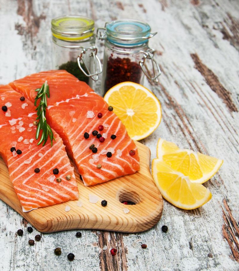 portions of fresh salmon fillet with aromatic herbs, spices and vegetables
